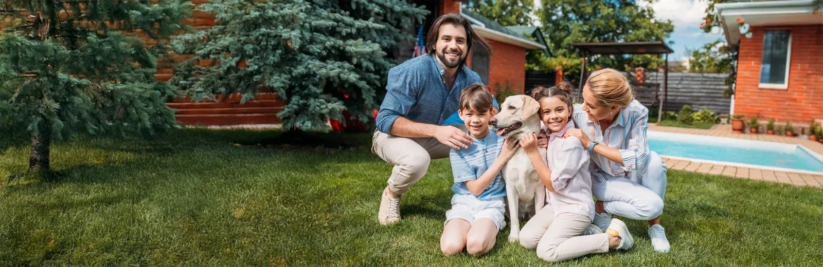 family playing outside with dog